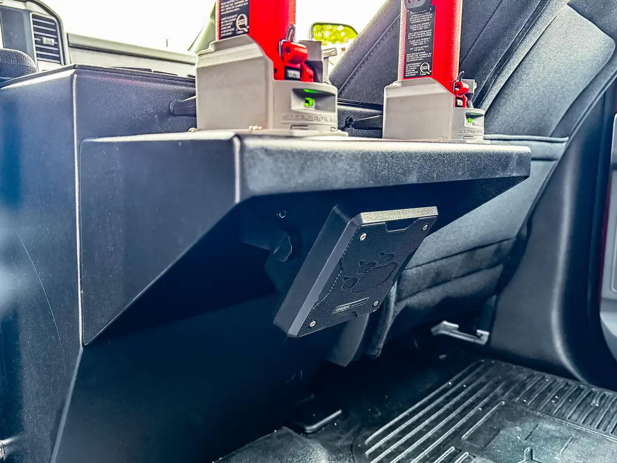 Rear console base close-up showing mounting bracket and floor area.